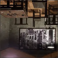 Room with furniture attached to the ceiling in an upside-down exhibit.