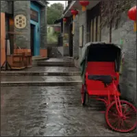 Bright red rickshaw parked along a traditional street in Lingnan Impressions Park.