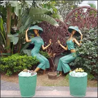 Decorative sculptures of two women displayed in a Guangzhou garden.