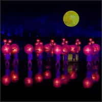 Performers carrying bright pink lanterns beneath a full moon.