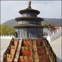 Ornate circular Chinese pavilion with a blue roof and decorated stairways