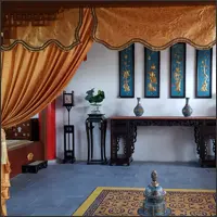 Symmetrical Chinese interior framed by gold-coloured curtains