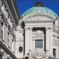 Ornate white European-style building with columns and a domed entrance