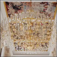Elaborate crystal chandeliers beneath a painted European-style ceiling