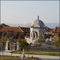 Wide view of Chinese and European-style buildings within the same landscaped park