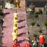 Group of performers in colorful costumes participating in an outdoor show.