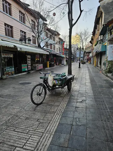 Cargo bike on a sparkling clean pedestrian street in Kunming’s old town in the early morning.