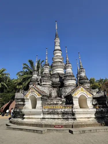 White multi-tiered stupa in Manting Park with traditional Southeast Asian architectural style