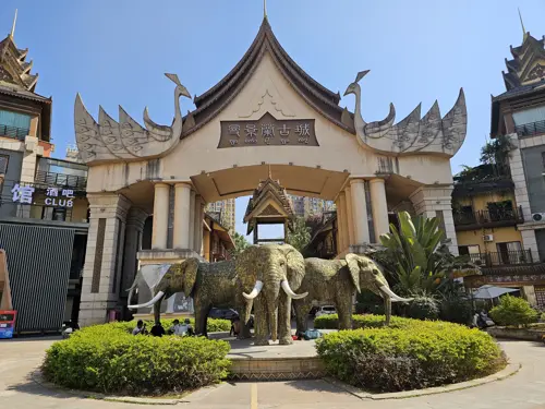 Entrance gate with traditional Dai-style architecture and elephant statues in Jinghong